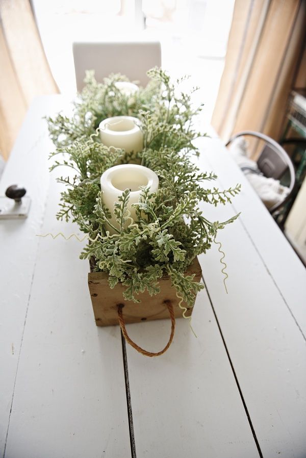 Wooden-box-filled-with-greenery-and-candles