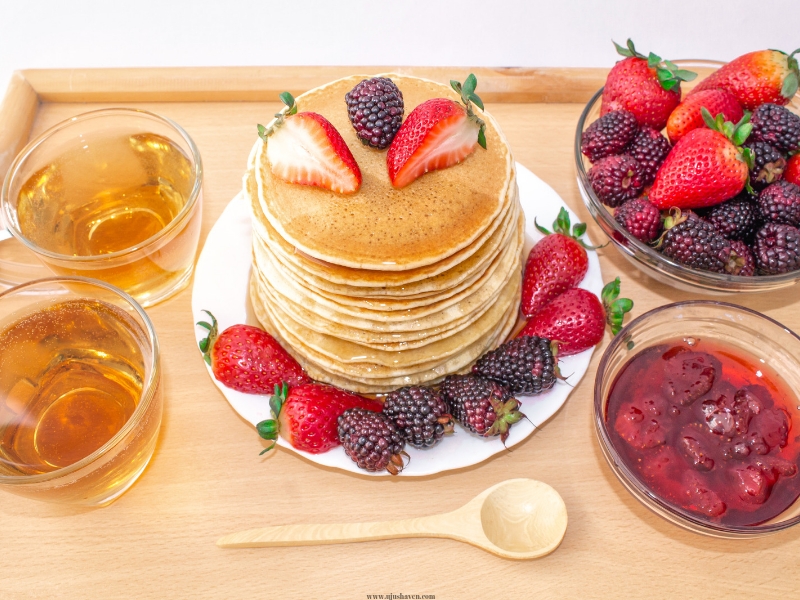 Pancakes-with-syrup-and-a-side-of-fruit.